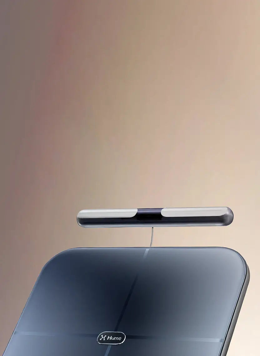Close-up of Hume Body Pod scale with detachable handlebar sensor, showcasing sleek design for advanced body composition measurement.