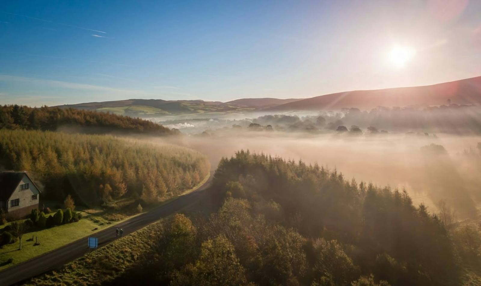 Mist over the wooded valley at sunrise
