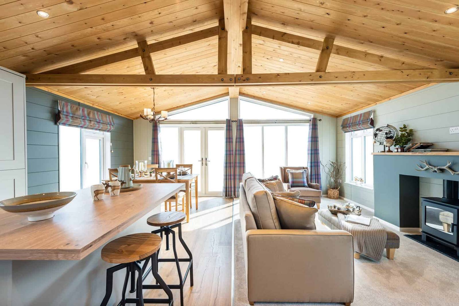 Open plan lounge with a breakfast bar inside a Lovat Parks holiday home