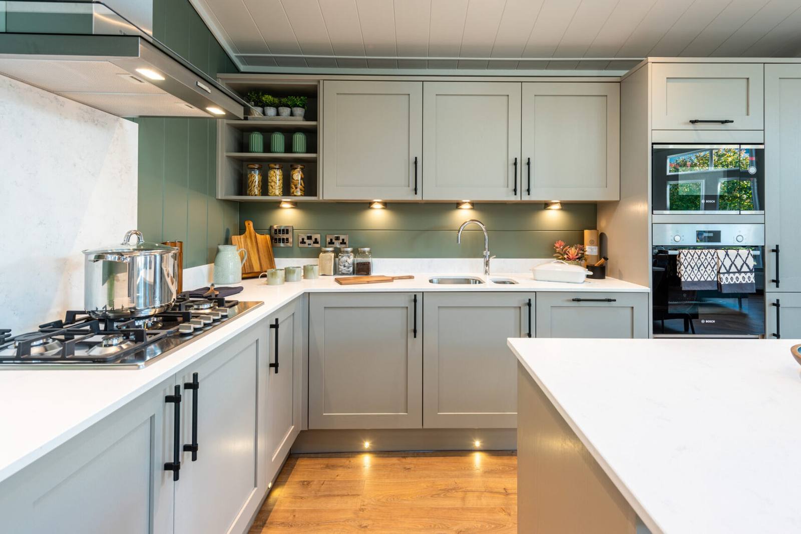 Kitchen with a sink and hob beside a glazed wall