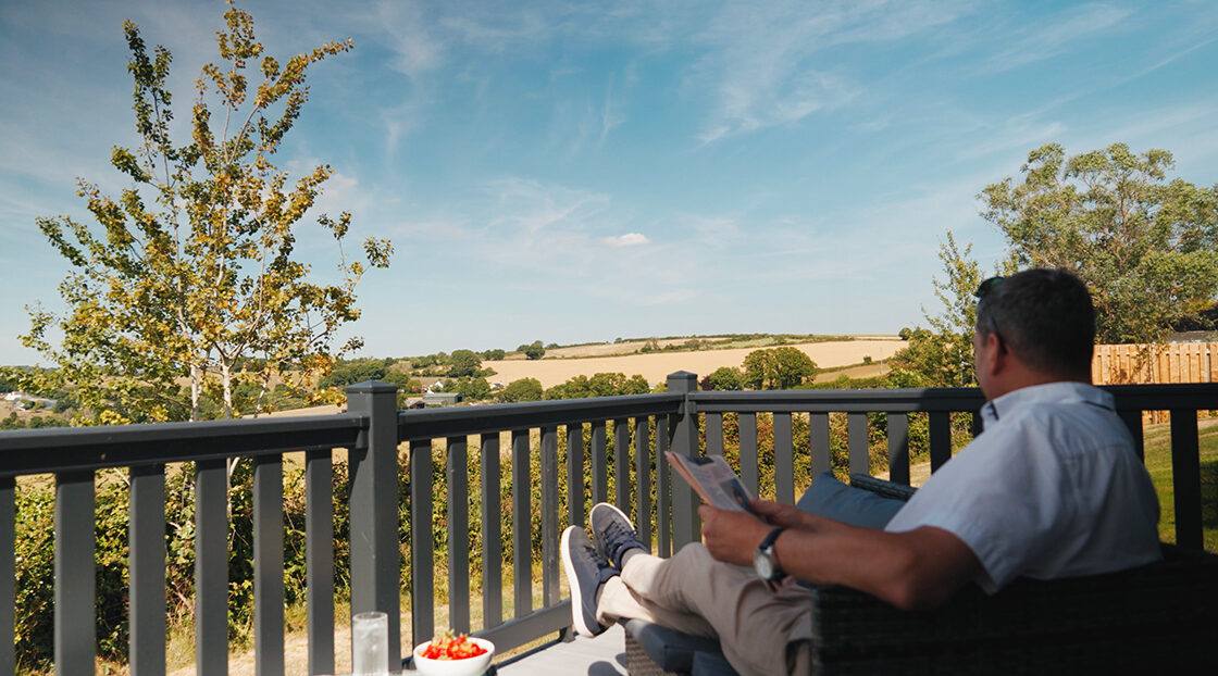 Decking outside a holiday home looking across the park