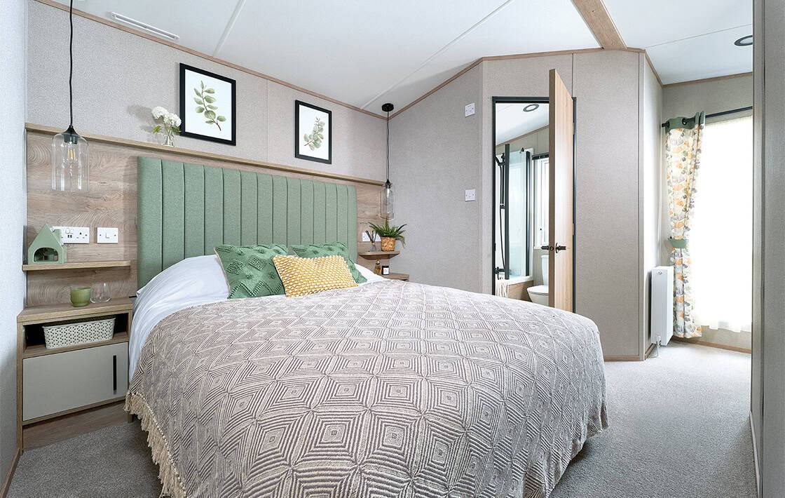 Main bedroom with soft furnishings inside a holiday home