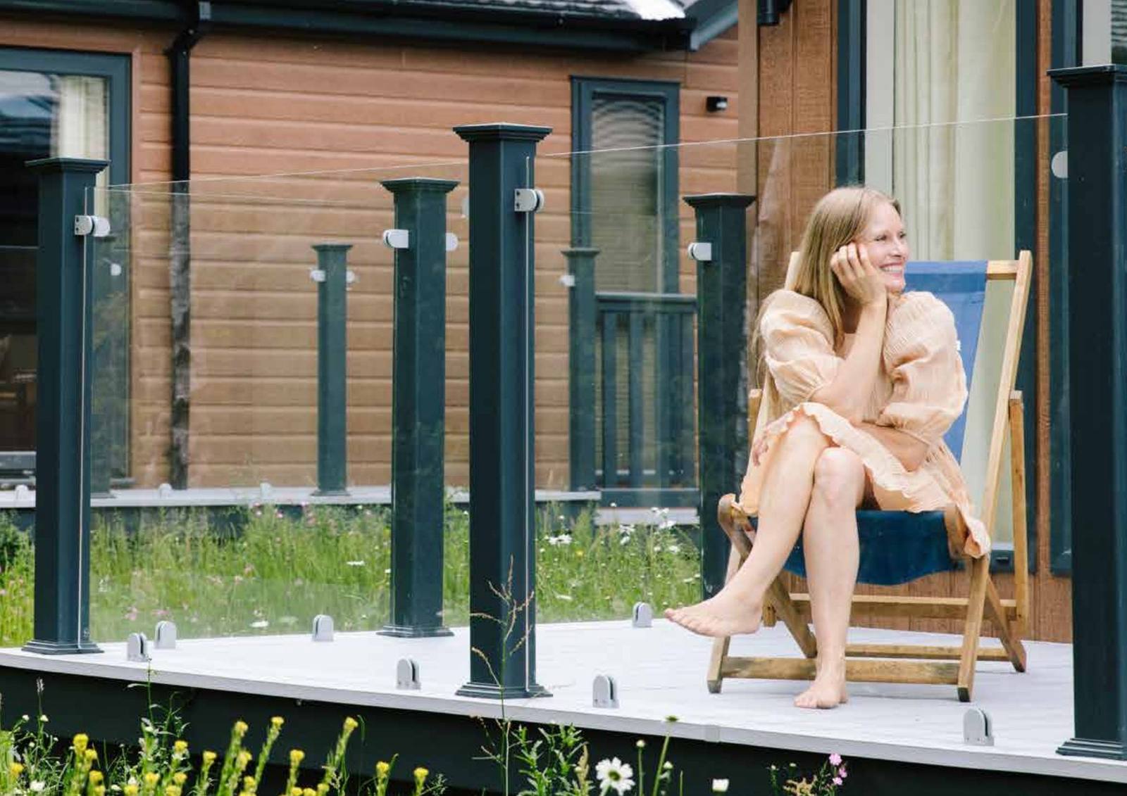 A woman relaxing on the decking of a holiday home